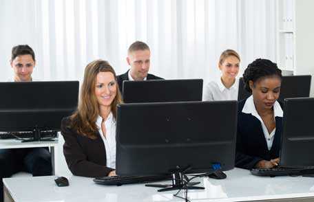 Instructor with students in classroom using computers