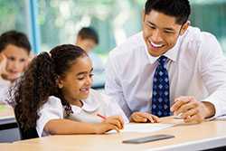 Teacher smiling and talking with student