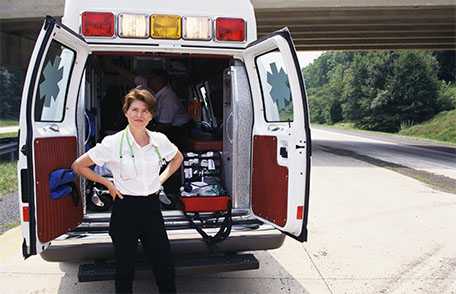 Woman standing in front of ambulance