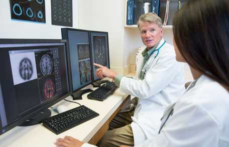 Health care workers reviewing MRIs