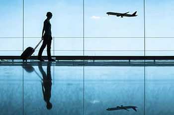 Woman pulling suitcase through airport