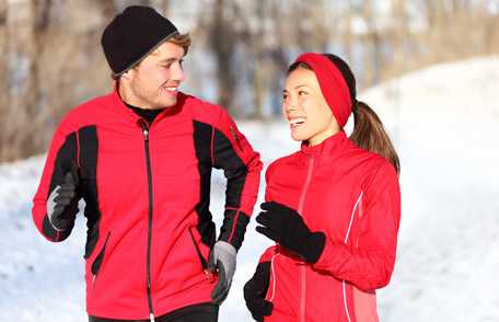 Man and woman wearing red and walking