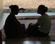 	Women chatting in doorway of health clinic.