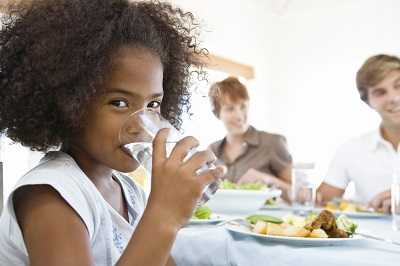 Little girl drinking a glass of water