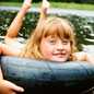 girl riding an intertube on a lake