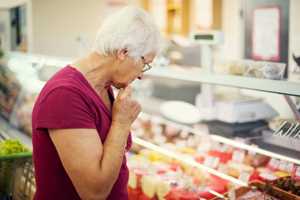 Lady in shop looking at food