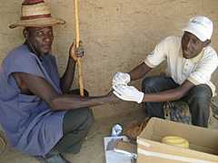 Hassan (right) with Mallam Ginger Isa (left) testing for HIV