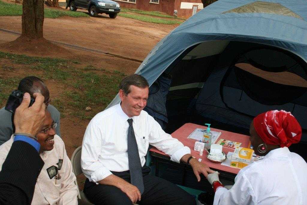 Secretary Leavitt gets his finger pricked by a CDC Rwanda staffer as Dr. Innocent Nyaruhirira (Rwanda’s State Minister for Health) looks on