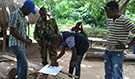 Dr. Alain (on the left in blue hat) from the Democratic Republic of Congo at a check point during border control efforts in Forécariah, Guinea.