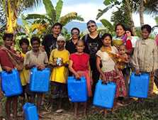 FETP investigator with local health workers providing jerry cans and oral rehydration solution in cholera outbreak affected villages. The outbreak investigation was conducted from April 7 to April 20, 2011. Bataraza, Palawan, Philippines, April 2011.