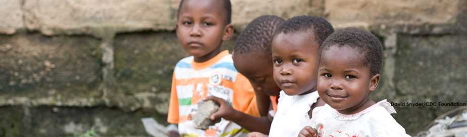 Children play on a small patch of grass in the community of Mikocheni in Dar Es Salaam, Tanzania's capital city. Through the Phones for Health program, supported by the CDC Foundation, the CDC is working to streamline Tanzania's health care reporting system so that local healthcare workers in both the public and private sectors can use text messaging and Interactive Voice Response (IVR) to report health trends at the local level to district level supervisors.