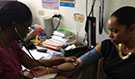 Patient at the Edgar Cochrane Polyclinic in Barbados having her blood pressure taken.