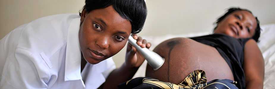 	A pregnant woman is examined by a nurse at the hospital in Zimba, Zambia where she expects to deliver her baby.