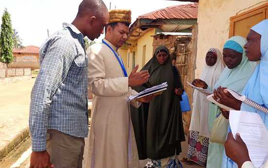 	Shafeeque Ahmad (STOP Volunteer) reviewing community mobilization plans with Volunteer Community Mobilizers in Kaduna