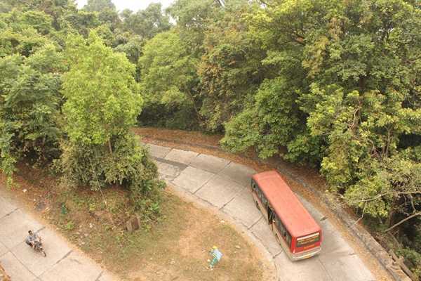 	A bus winds its way up a hilly road in Western Ghat.