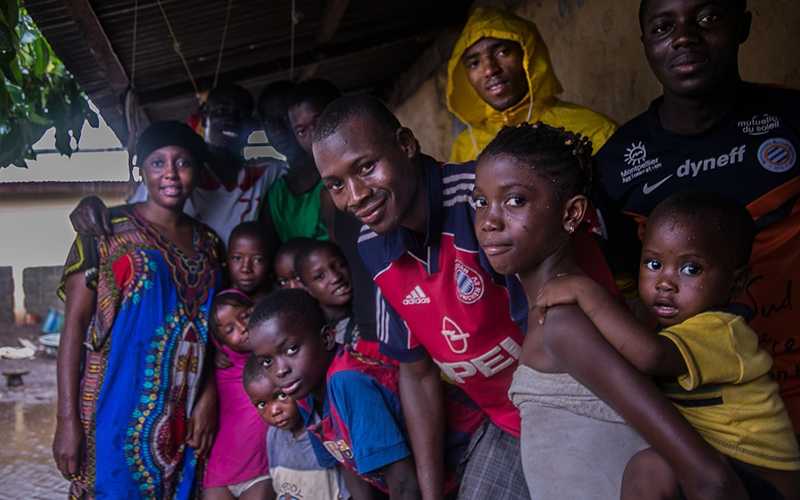 Mr. Camara and a family in his community