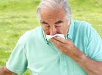 Photo of man sneezing