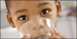 Photo: A boy dinking a glass of water.