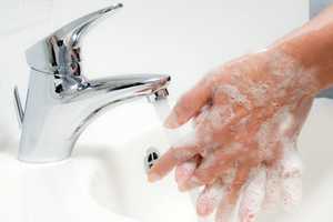 Person washing their hands with soap and water