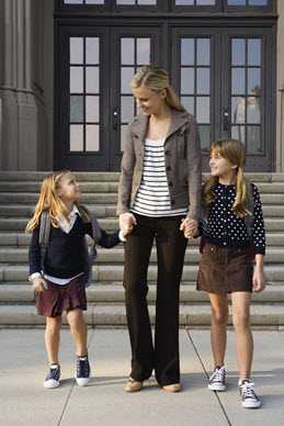 Mother and daughters leaving school