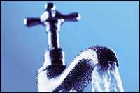 Photo: Water pouring out of a faucet.