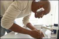 Photo: A man shaving.