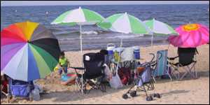 People under umbrellas on a beach