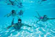 A family swimming underwater.