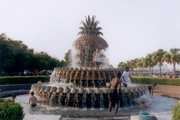 Kids playing in a decorative water fountain.