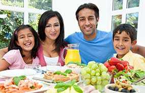 photo of a man and two children eating