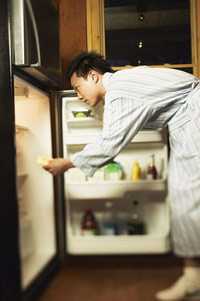 	photo of man in front of open refrigerator