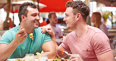 Photo of two men on a date at a cafe