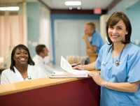 	photograph of nurses at a nurse station in a hospital