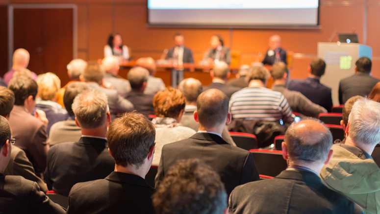 a conference meeting in an auditorium