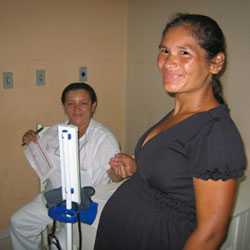 Nurse taking woman's blood pressure