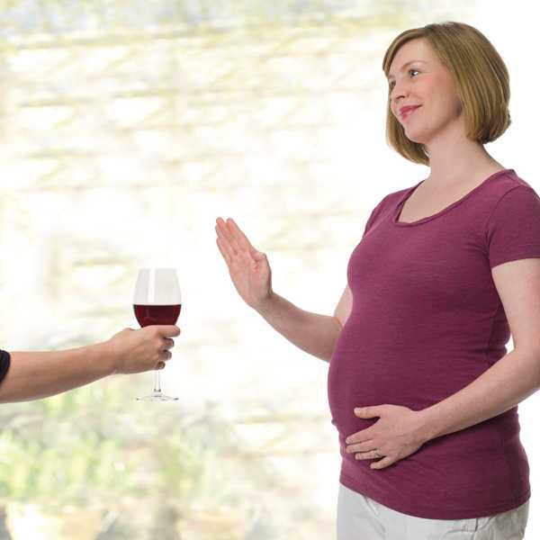 Pregnant woman saying no to wine 