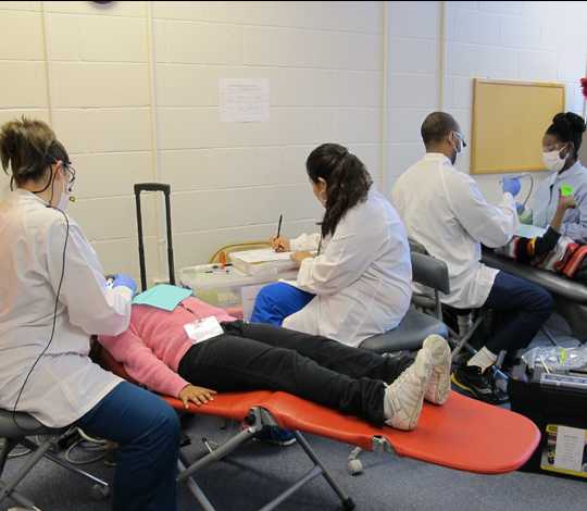 several dentists working on two patients