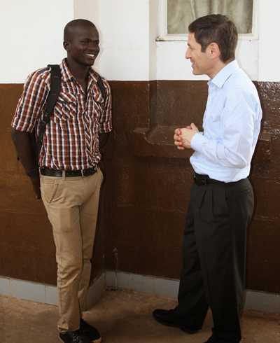 Dr. Tom Frieden speaks with Yusif Koroma, an Ebola survivor who is now taking of orphans at a nearby social services center.