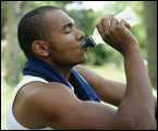 A man drinking water outside