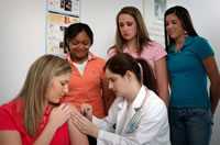 Teenage girl receives vaccination