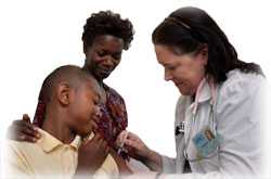 The nurse in this 2006 image was in the process of administering an intramuscular injection into the left shoulder muscle of this 13-year old boy as his mother looked on. He was assisting in the injection by holding up his shirt sleeve in order to expose the immunization site.