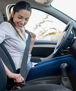 Woman fastening seatbelt