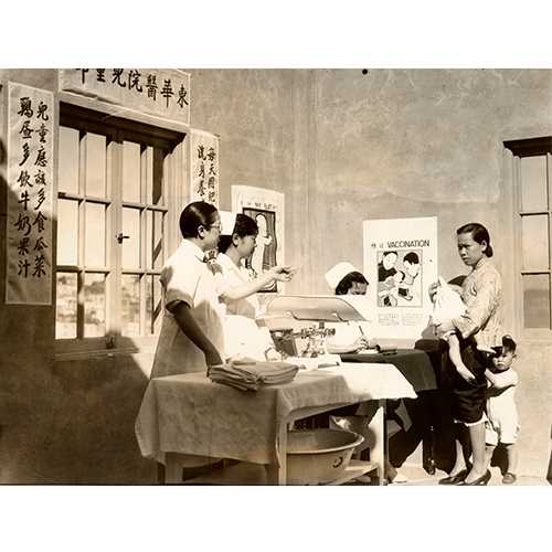 San Francisco History Center, San Francisco Public Library  -  A doctor coaxing a child with his mother at a Chinatown Well Baby Clinic, San Francisco, 1934  -  In 1921, Congress passed the Maternity and Infancy Act to provide instruction in maternity and infant care. Through this funding, “Well Baby Clinics” were held across the country, typically segregated by ethnicity or race. 