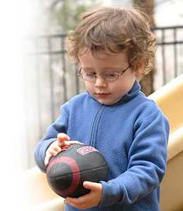 Little boy studying a football