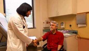 A man in a wheel chair visiting the doctor. 