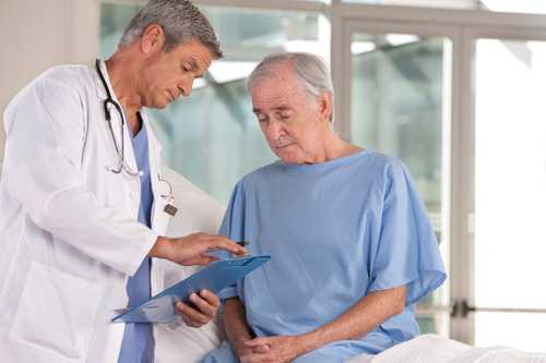 Doctor talking to senior male patient