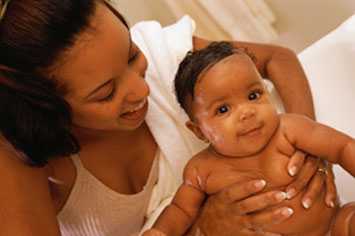 Mom bathing her baby