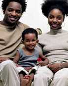 Toddler boy sitting with parents