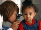 Doctor looking in a child's ear.