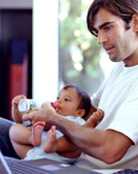 Dad feeding baby a bottle